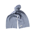 A neatly folded, light blue knitted Lambswool scarf from Le Bonnet is tied in a knot with a small white label attached.