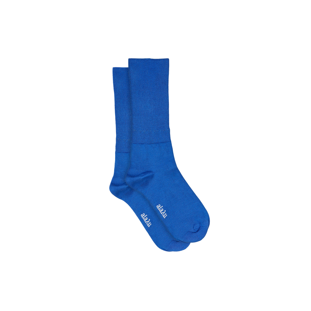 Indulge in luxury with Aiayu's Silk Socks in blue, designed for ultimate comfort and style. These breathable crew socks showcase white text near the toes against a plain background.