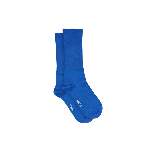 Indulge in luxury with Aiayu's Silk Socks in blue, designed for ultimate comfort and style. These breathable crew socks showcase white text near the toes against a plain background.