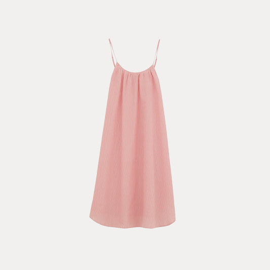 The Aiayu Strap Dress Petite, a pink and white striped sleeveless gown with thin spaghetti straps, beautifully complements your sleepwear collection as it hangs gracefully against a plain white backdrop.