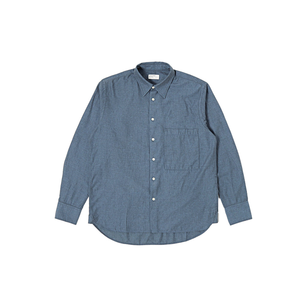 The "Italian Brushed Twill Square Pocket Shirt" by Universal Works is a dark blue, long-sleeve button-down shirt made of 100% cotton, featuring a chest pocket and adjustable button cuffs, displayed against a white background.