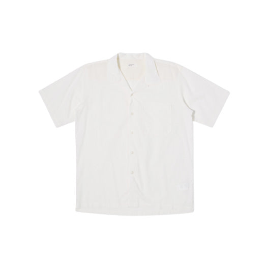 A white Camp Shirt from Universal Works, featuring a relaxed fit with short sleeves and an open collar, is displayed laid flat on a white background.