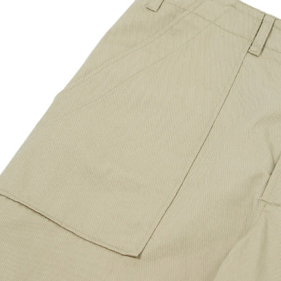 Close-up of the Fatigue Pant Twill in Stone by Universal Works, showcasing pocket details and belt loops.