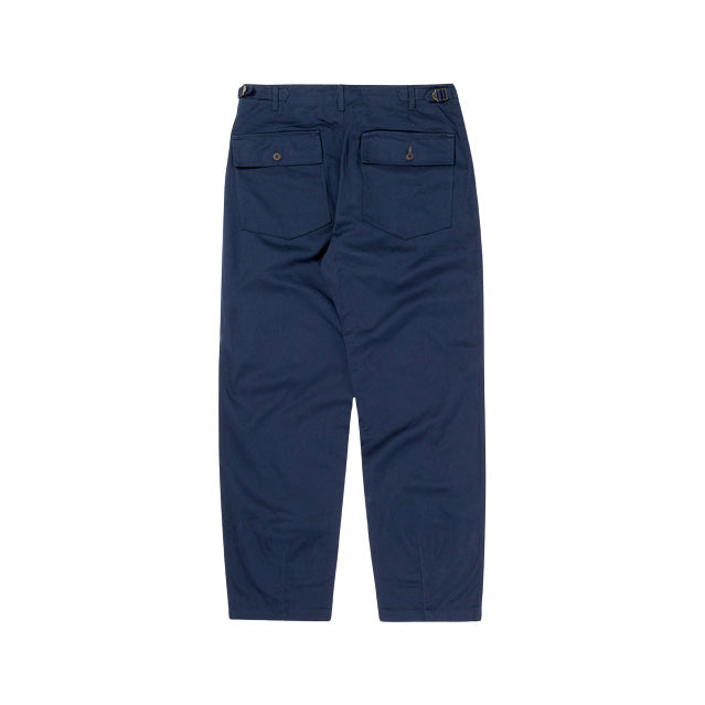 The Universal Works Fatigue Pant Twill in Navy features an oversized fit with a military-inspired design, showcasing a back view with two buttoned pockets and adjustable side tabs in a twill weave.