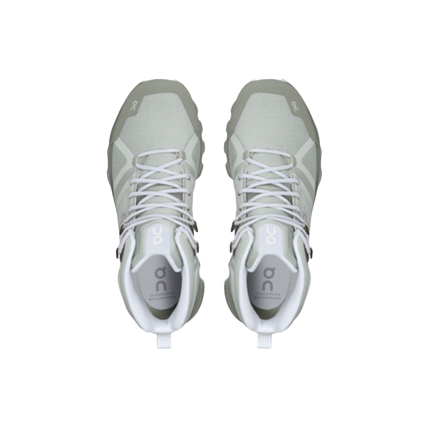 A top view of the Women's Cloudrock 2 Waterproof shoes by On Running, featuring a light grey design with a CloudTec® outsole and white laces, patterned soles showcased against a black background.