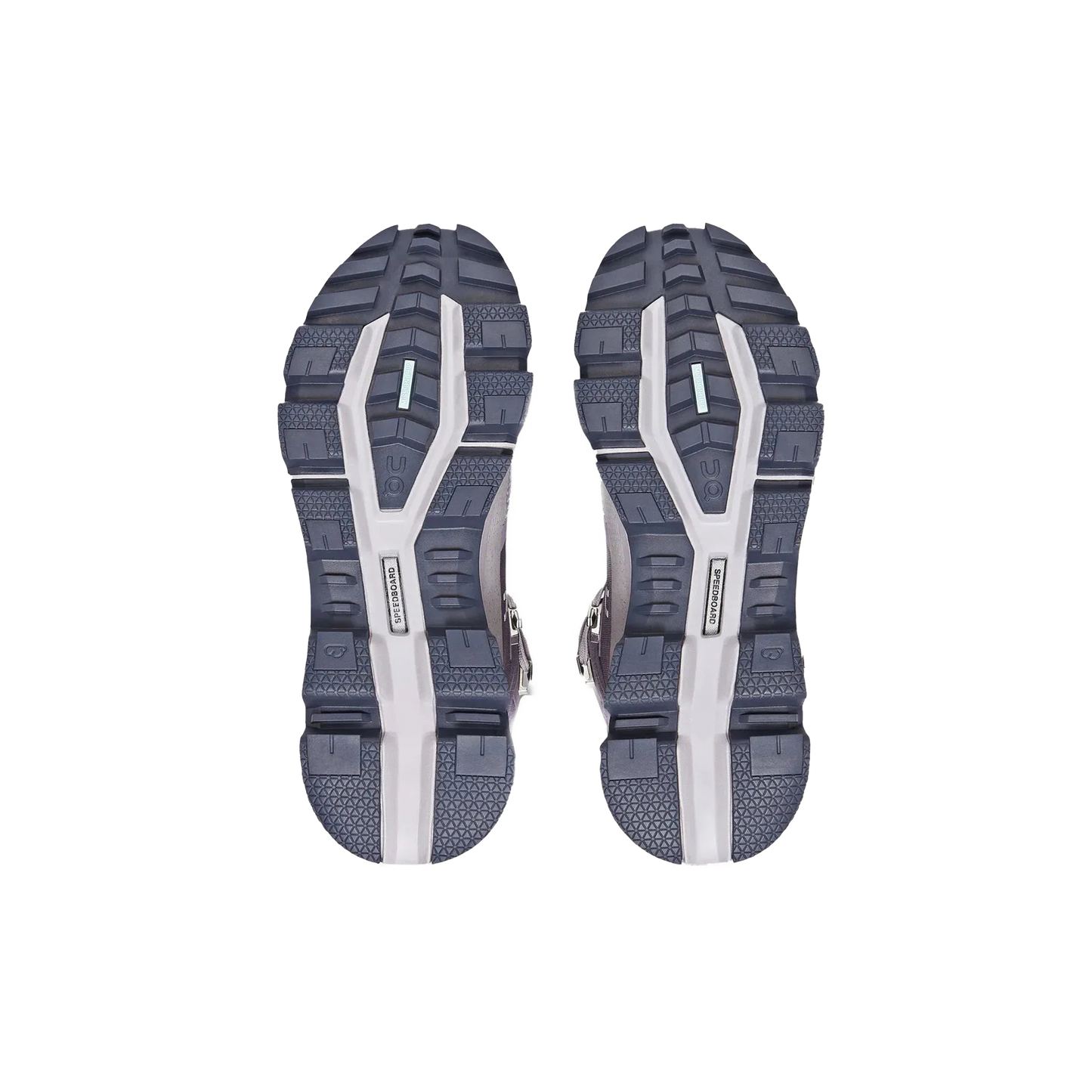 The image displays the soles of On Running's Women's Cloudrock 2 Waterproof shoes, which are gray and white with detailed tread patterns and feature the CloudTec® outsole for improved performance.