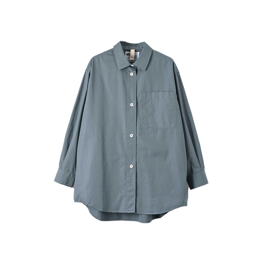 Introducing the W Oversized Painters Shirt by Margaret Howell - a loose-fitting shirt crafted from compact cotton poplin in light blue. It features a single chest pocket, white buttons, and tapered sleeves, beautifully showcased against a white background.