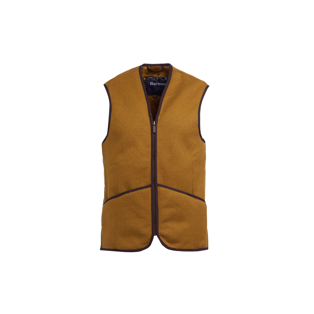 The Barbour M Warm Pile Waistcoat Zip-In Liner is a sleeveless brown fleece vest with a front zipper and dark brown trim, designed to be a versatile addition to Barbour jackets. It prominently features the iconic "Barbour" label inside.