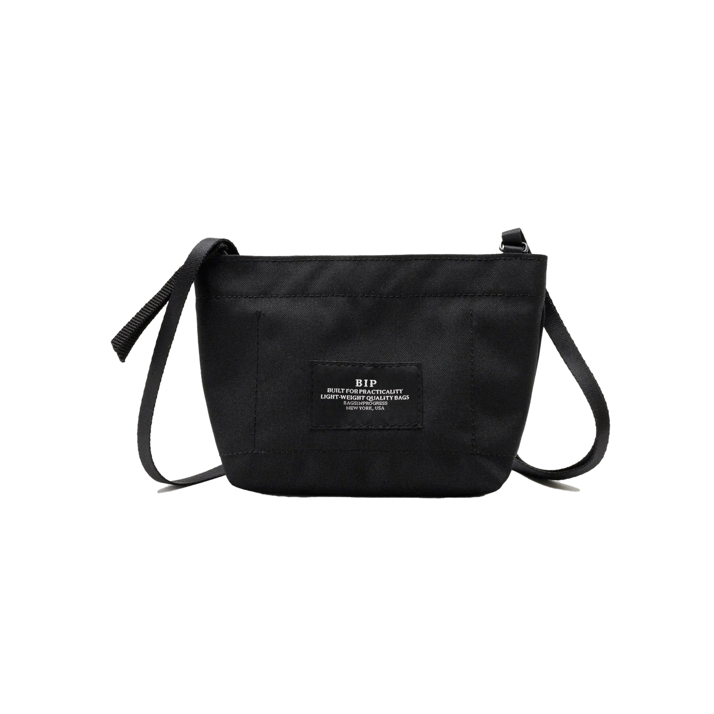 The Zipper Pouch Mini by Bags in Progress is a compact black shoulder bag made from recycled polyester, showcasing a front patch adorned with white text.