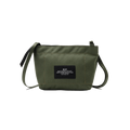 The Zipper Pouch Mini by Bags in Progress is a mini shoulder bag in olive green made from recycled polyester. It includes a black label on the front with text and offers water-repellent protection, featuring a single zip closure and an adjustable black strap, ideal for everyday use.