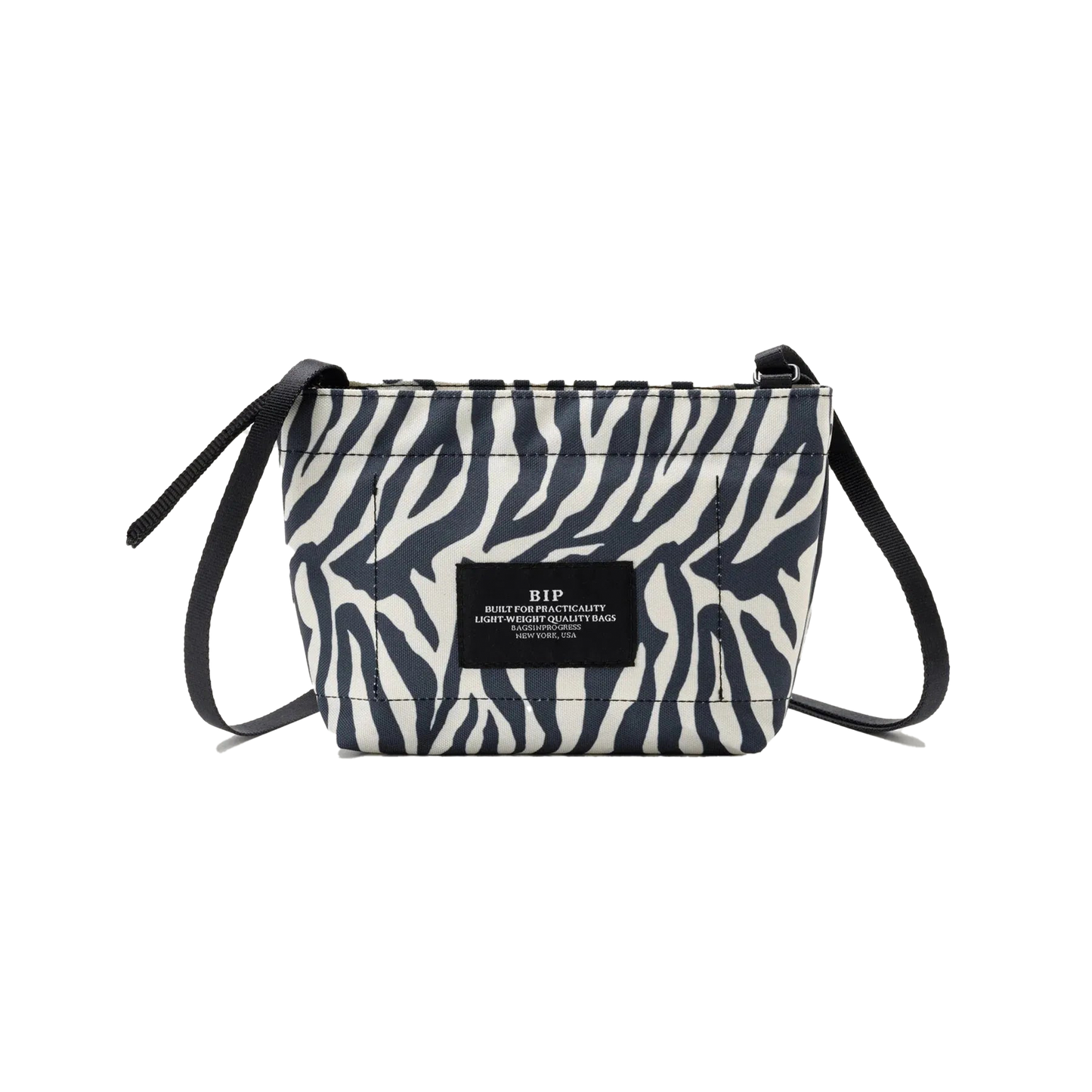 Introducing the Zipper Pouch Mini by Bags in Progress, a stylish shoulder bag featuring a zebra-print design crafted from recycled polyester. It is accented with black drawstrings and includes a label on the front.